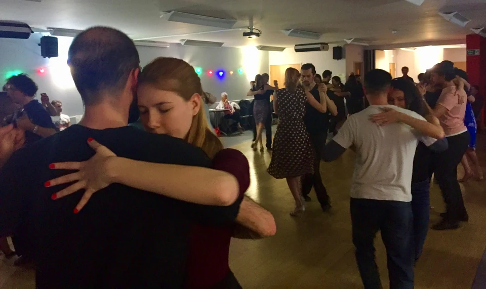 Couples dancing tango in a studio setting