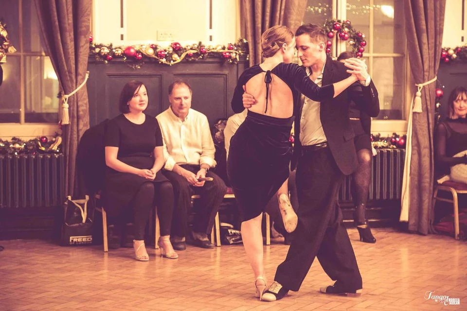 Couple dancing Argentine Tango in a festive setting