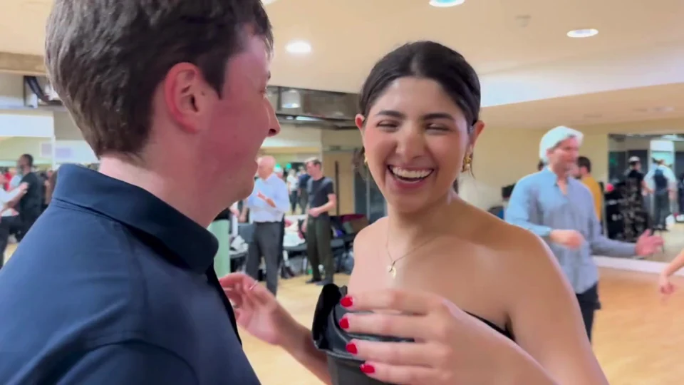 Couple dancing in a tango class setting