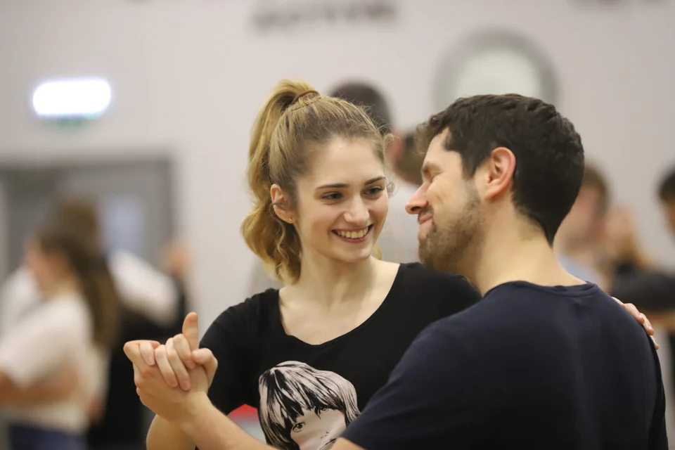 Couple dancing in a dance studio setting