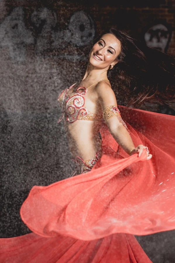 Belly dancer in red costume with flowing fabric