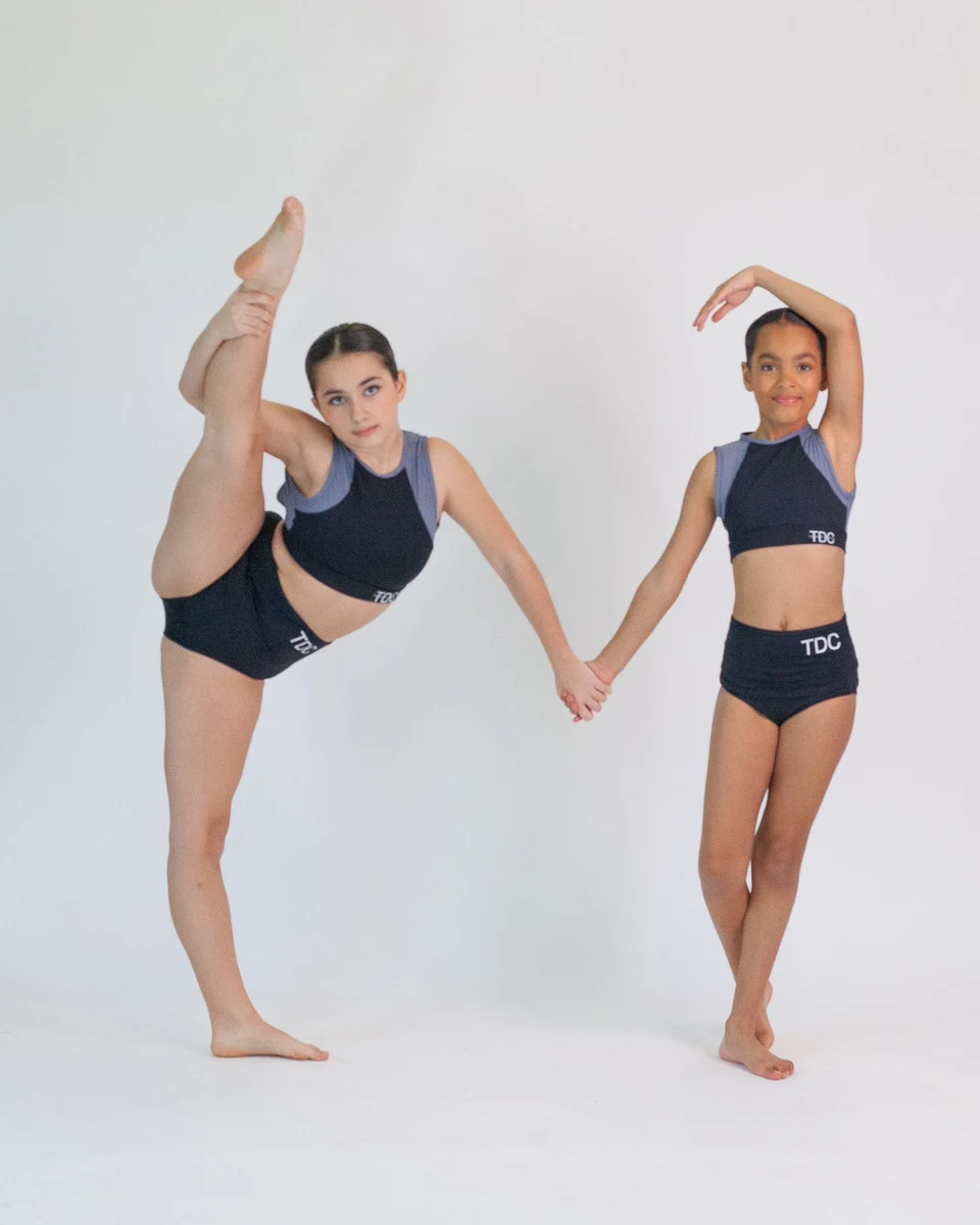 Two young dancers posing in dance attire