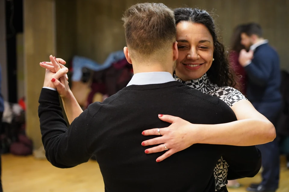 Couple dancing Argentine Tango in a studio