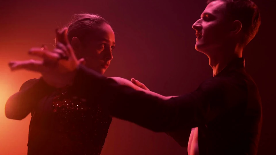 Couple dancing in dramatic lighting