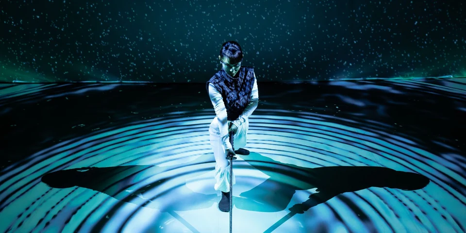 Dancer performing on a circular illuminated stage