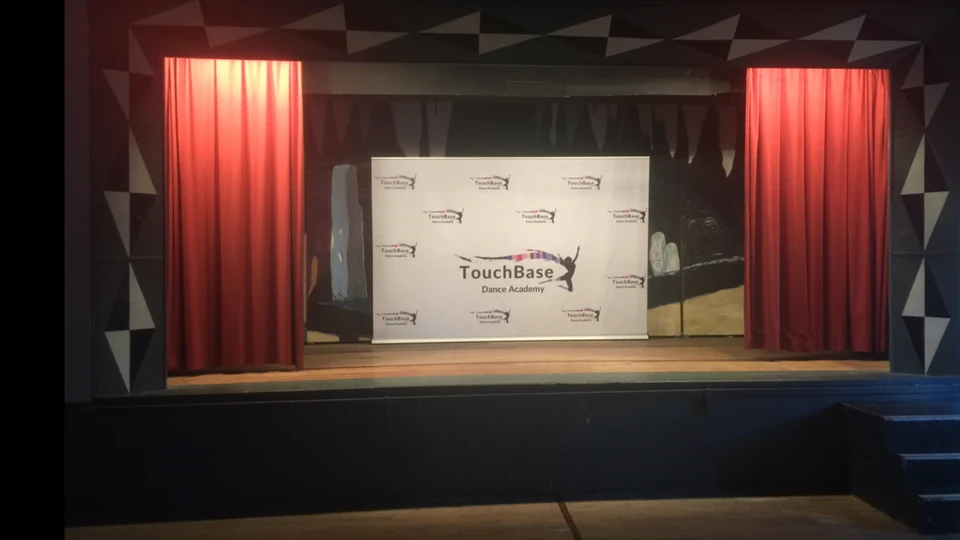 Stage with red curtains and a banner