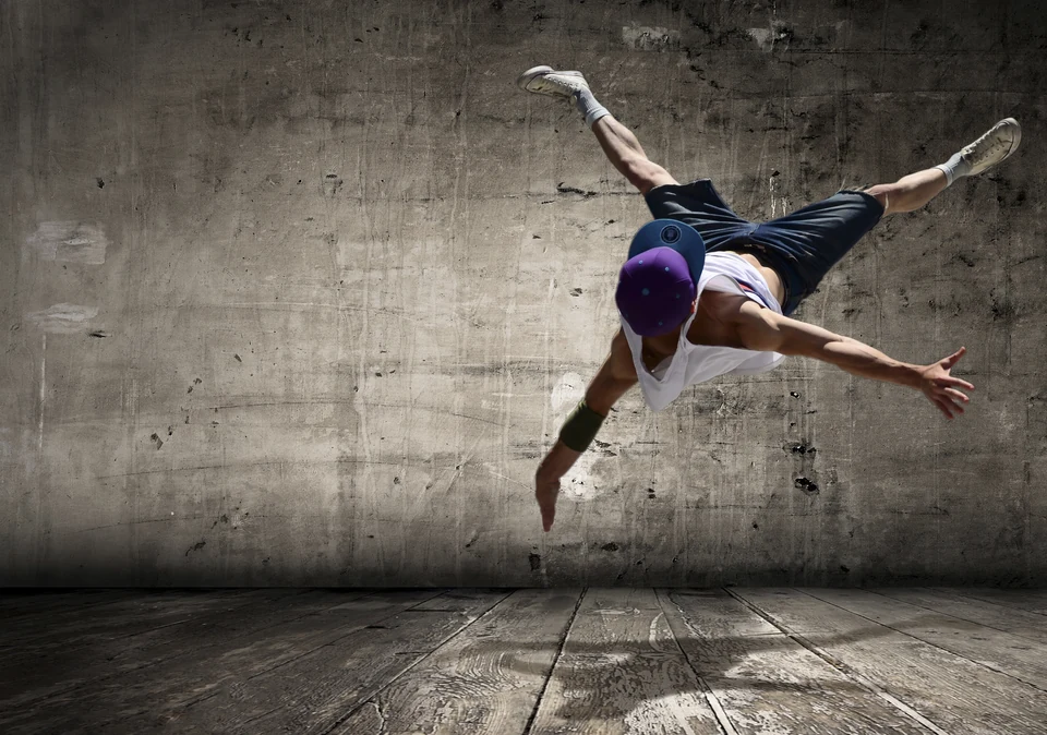 Breakdancer performing a move in an urban setting