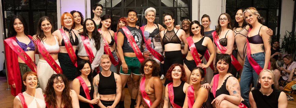 Group of dancers in a studio with sashes