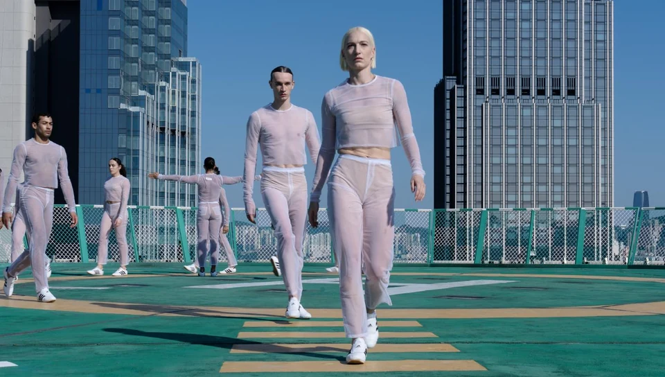 Dancers in sheer outfits on a rooftop space