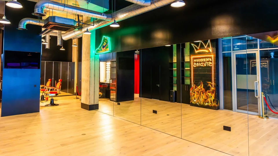 Dance studio interior with mirrors and neon lights